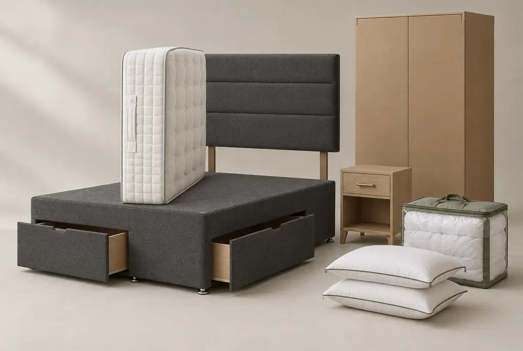 A complete contract bedroom package set out in a studio: storage divan base, pocket-sprung mattress, grey headboard, flat-packed wardrobe carton, bedside table and a packed dressing set.